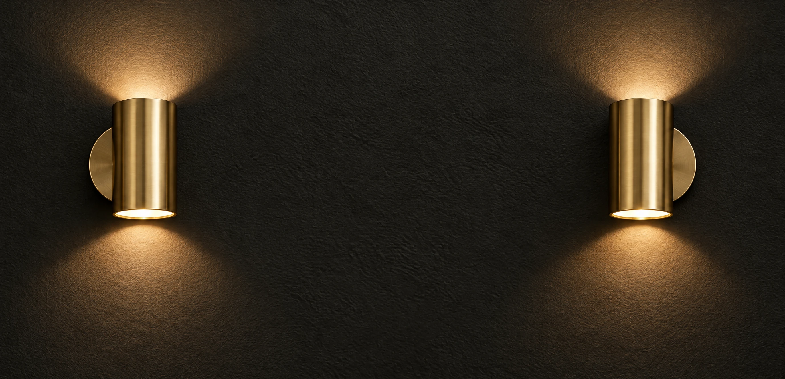 Illustration of a matching pair of brushed-brass wall sconces glowing on a dark plaster wall